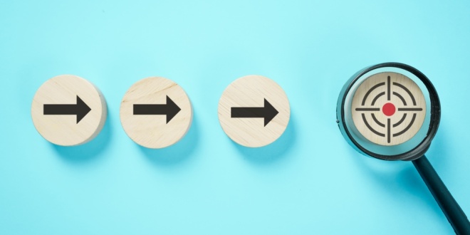 Three right facing arrows pointing to a crosshair under a magnifying glass, symbolising the government's plans to target illegal gambling advertising