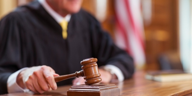 Gavel banging, representing the New Jersey Court rejecting an Evolution request