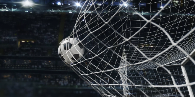 A football touches the back of the net, going with the article's topic, the World Cup.