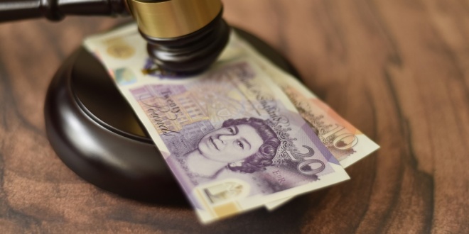 Pound notes under a judge's gavel, symbolising money laundering
