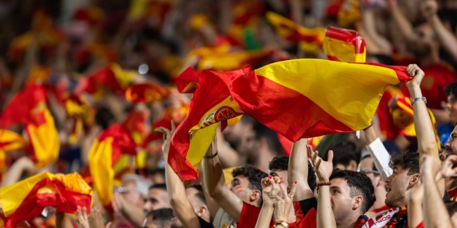 Spanish football fans waving a flag - the team has won the 2026 FIFA World Cup