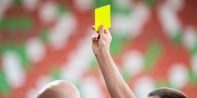 A yellow card, representing how close Evolution came to losing its licence