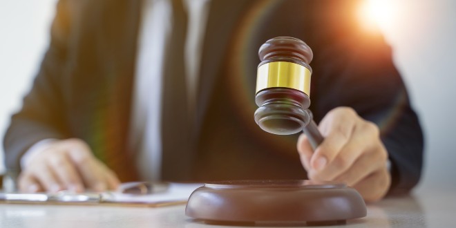 gavel banging, representing the ASA's decision to ban Midnite's ad campaign