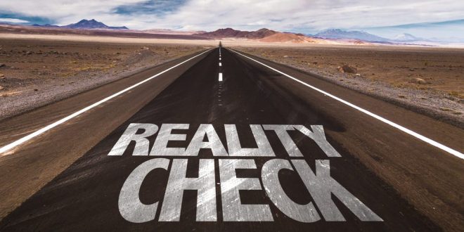 A road reading reality check, symbolising Entain's tax burden