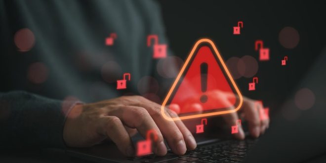 A red alert icon above a laptop, symbolic of a data breach such as the one which occurred at Oddschecker recently