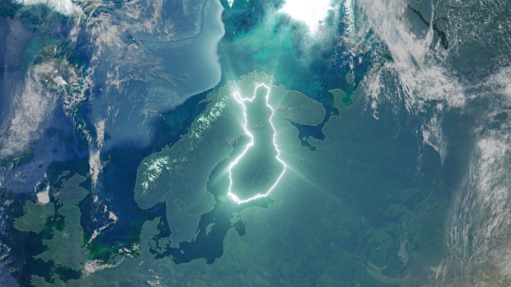 Borders of Finland illuminated on a map, symbolic of Veikkaus and Fennica's global expansion