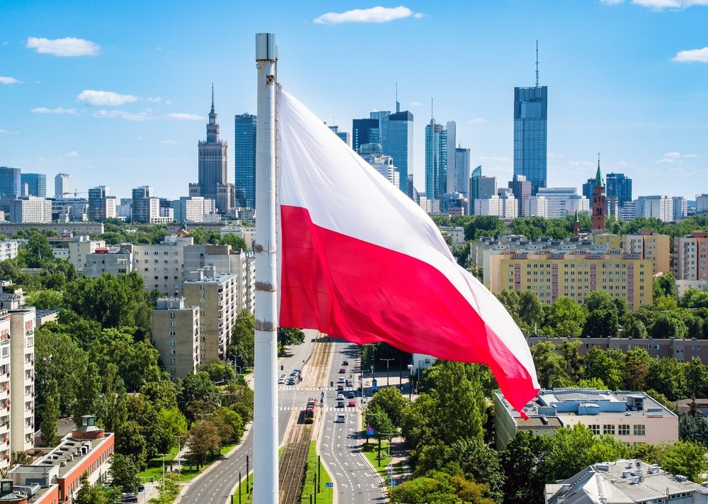 Polish national flag against skyscrapers in Warsaw