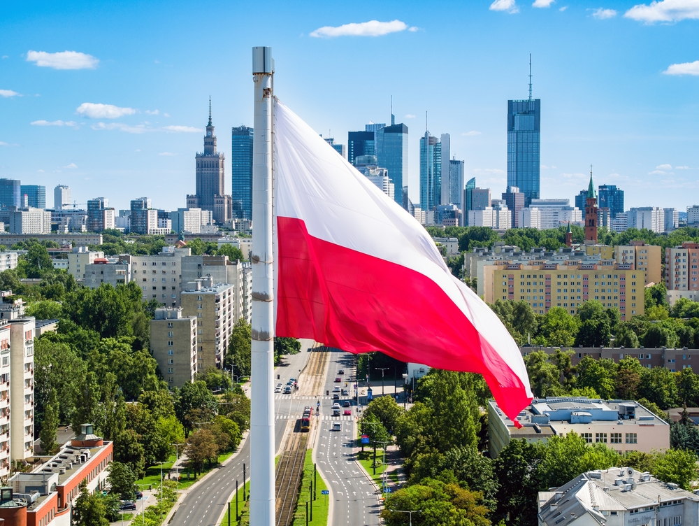 Polish national flag against skyscrapers in Warsaw